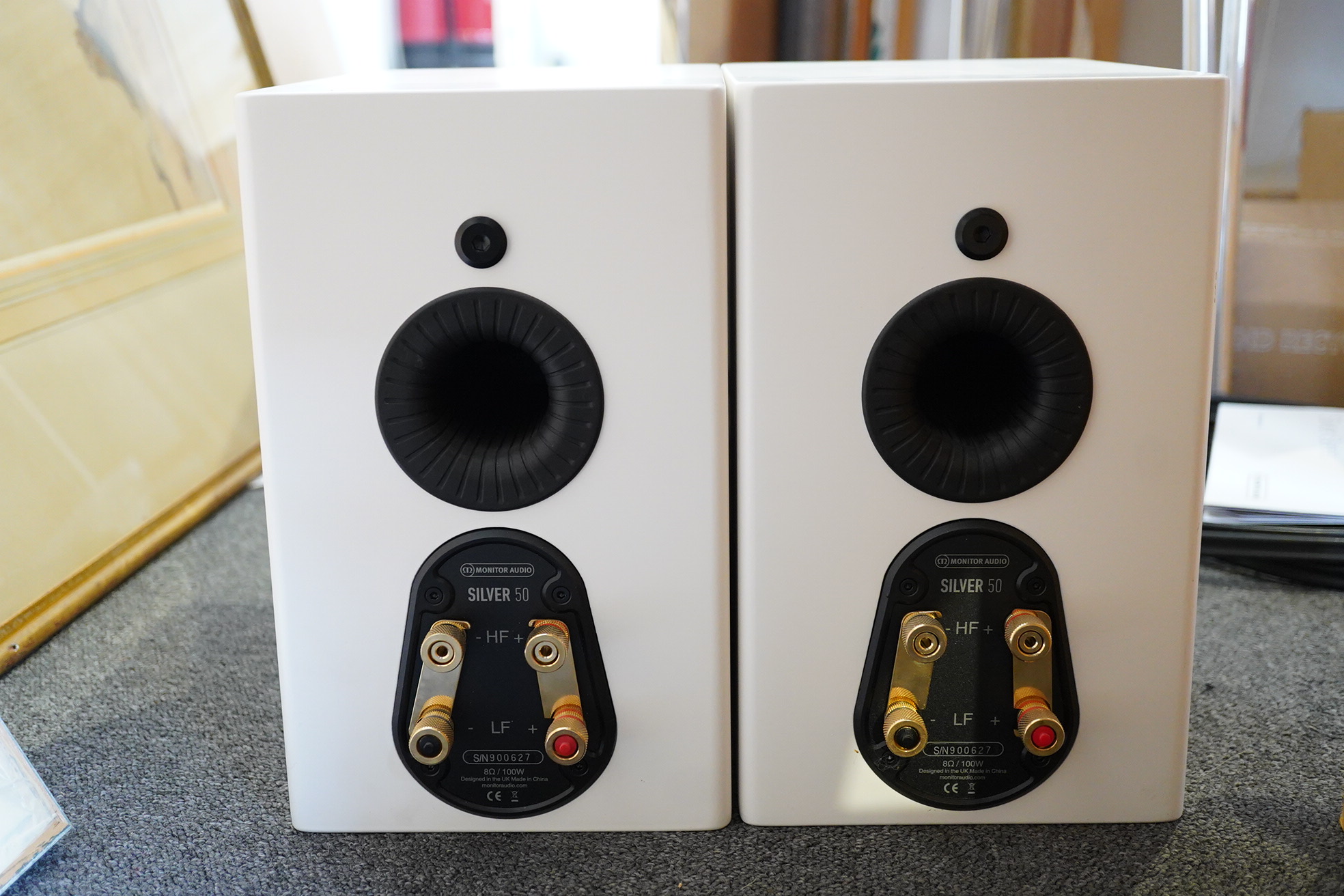 A pair of Monitor Audio Silver Series ‘Silver 50’ stereo monitor speakers in satin white cases, height 27cm, width 16.5cm, depth 25cm, together with the silver series specification booklet and two related audio cables